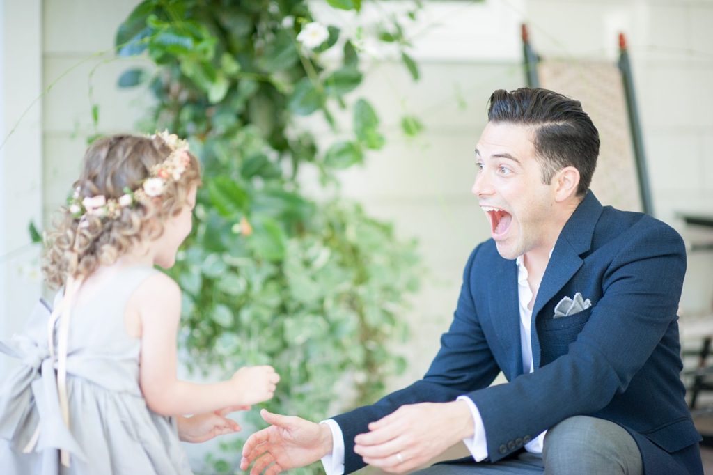 Hamptons wedding photographer captures two grooms for a same sex wedding at a private home. Flower girl image by Mikkel Paige Photography.