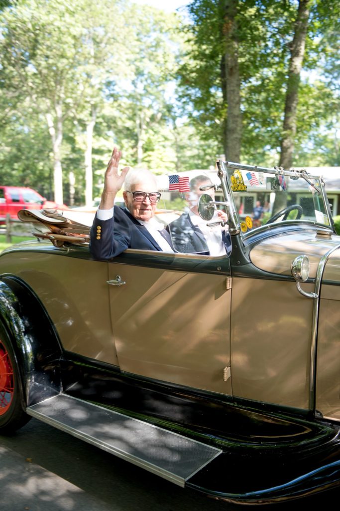 Hamptons wedding photographer captures two grooms for a same sex wedding at a private home. Images by Mikkel Paige Photography of the groom and his father in a vintage car.