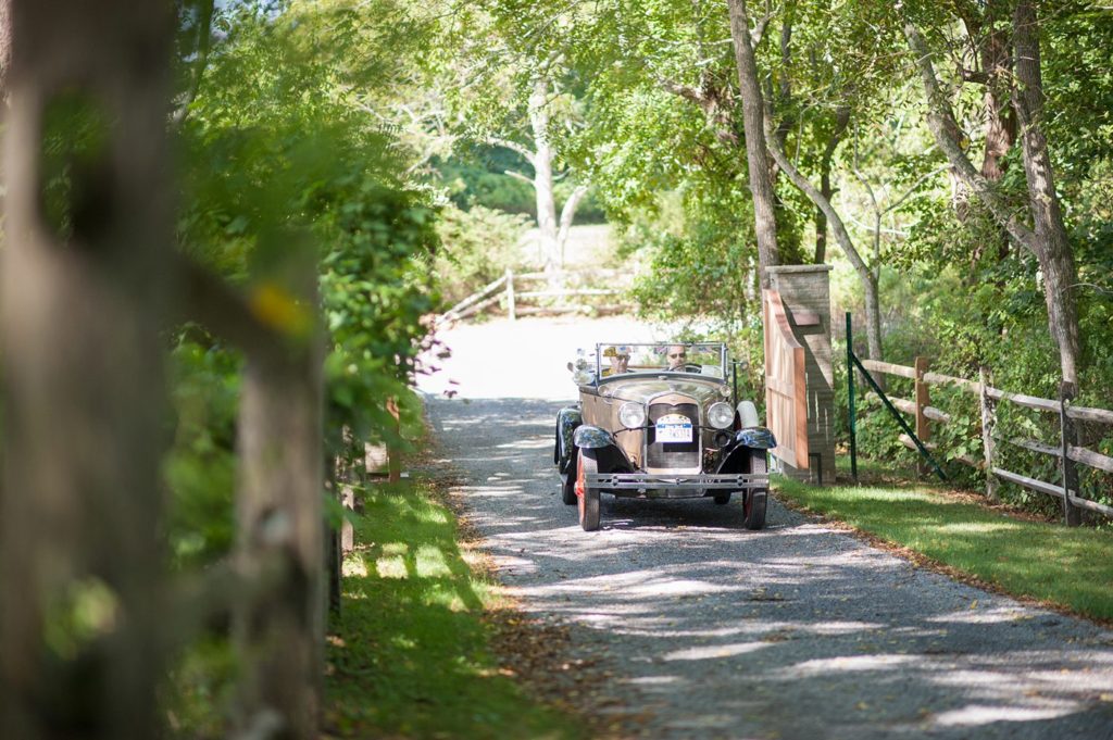 Hamptons wedding photographer captures two grooms for a same sex wedding at a private home. Images by Mikkel Paige Photography of the groom and his father in a vintage car.