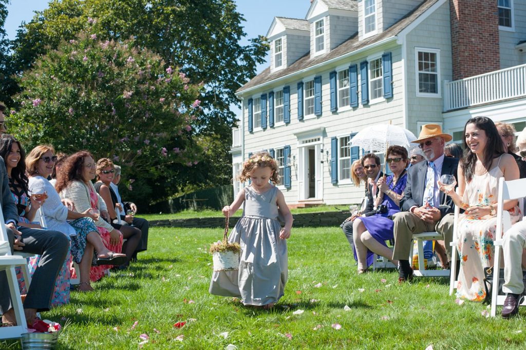 Hamptons wedding photographer captures two grooms for a same sex wedding at a private home. Outdoor ceremony images by Mikkel Paige Photography.