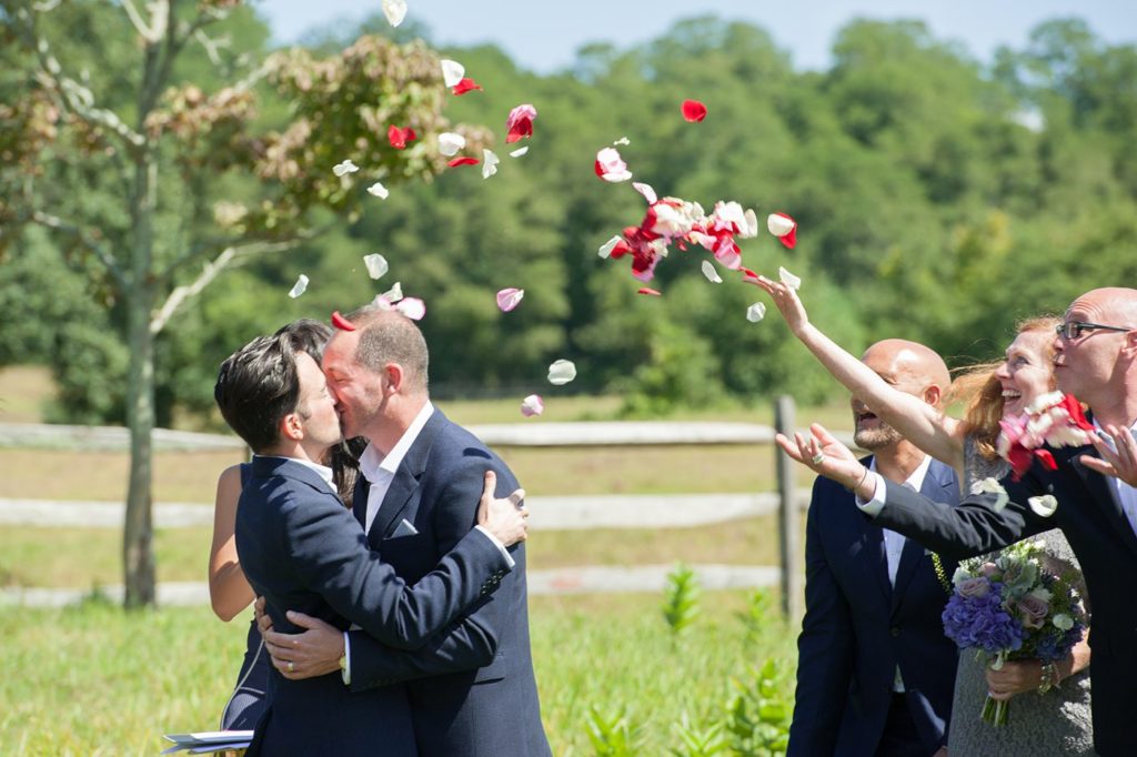 Hamptons wedding photographer captures two grooms for a same sex wedding at a private home. Outdoor ceremony images by Mikkel Paige Photography.