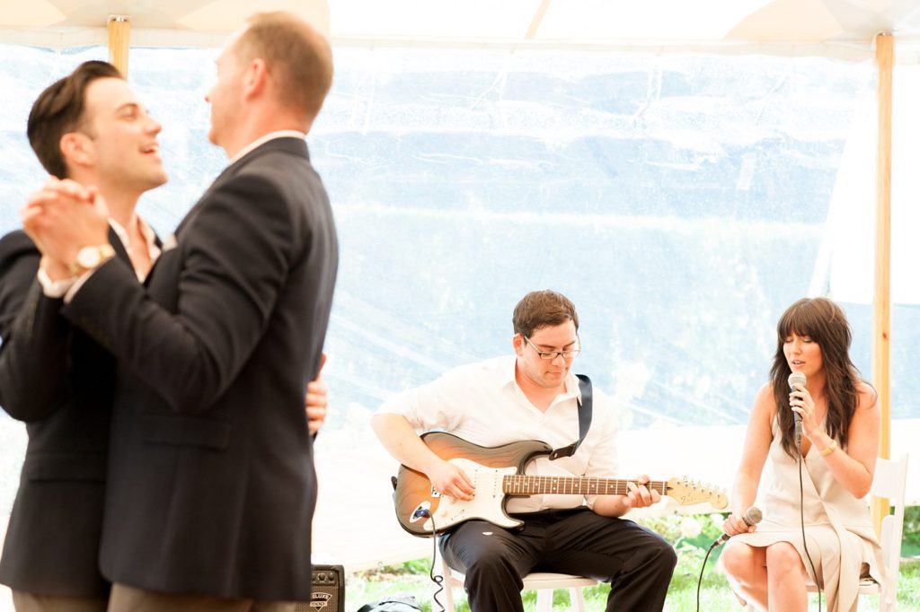 Hamptons wedding photographer captures two grooms for a same sex wedding at a private home with a tented outdoor reception. Images by Mikkel Paige Photography.