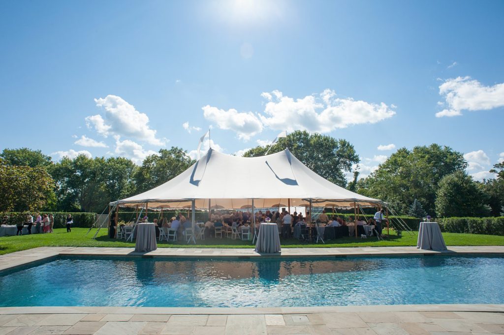 Hamptons wedding photographer captures two grooms for a same sex wedding at a private home with a tented outdoor reception. Images by Mikkel Paige Photography.