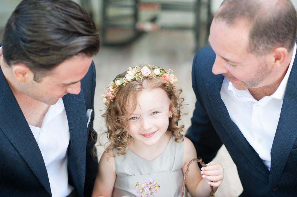 Hamptons wedding photographer captures two grooms for a same sex wedding at a private home with a wedding party in navy and grey. Images by Mikkel Paige Photography.