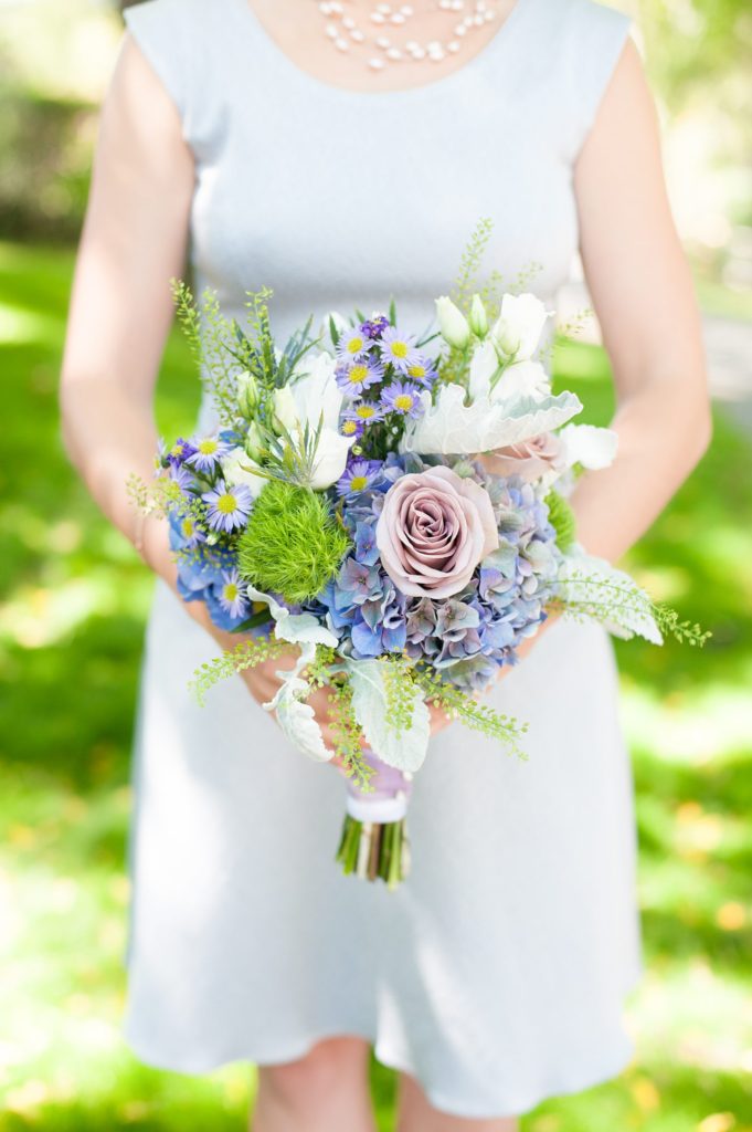 Hamptons wedding photographer captures two grooms for a same sex wedding at a private home with purple and green flowers. Images by Mikkel Paige Photography.