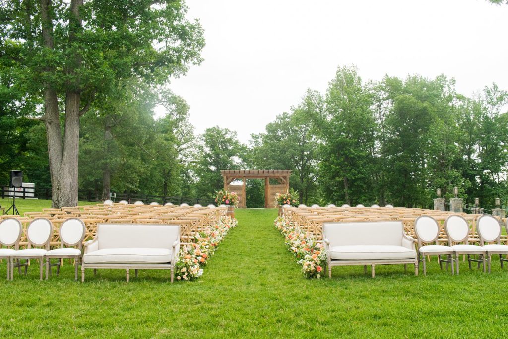 Mount Ida Farm wedding photos by Mikkel Paige Photography with an outdoor ceremony overlooking the Blue Ridge Mountains. Flowers by Meristem Floral and planning by Viva L'Event. Couches by Cottage Luxe.