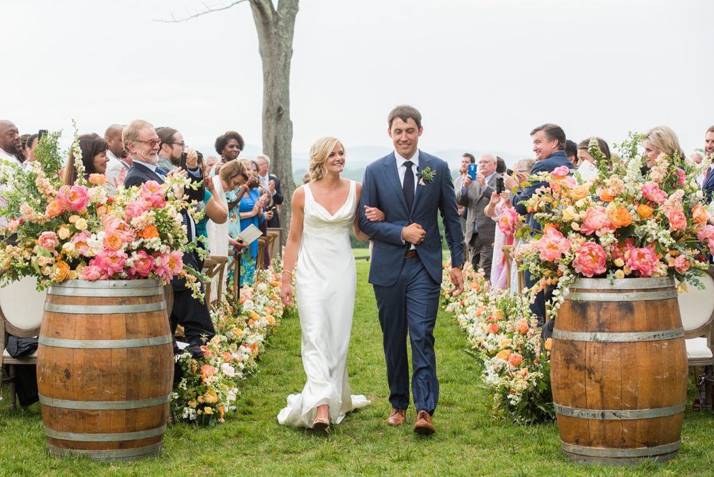 Mount Ida Farm wedding photos by Mikkel Paige Photography with an outdoor ceremony overlooking the Blue Ridge Mountains. Flowers by Meristem Floral and planning by Viva L'Event. Couches by Cottage Luxe.