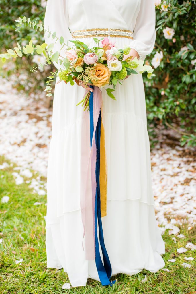 Small wedding in North Carolina with photos by Mikkel Paige Photography. The bride and groom got married in an intimate setting at historic Leslie-Alford Mims House in Cary. The bride carried a fall bouquet with jewel tone silk ribbons.