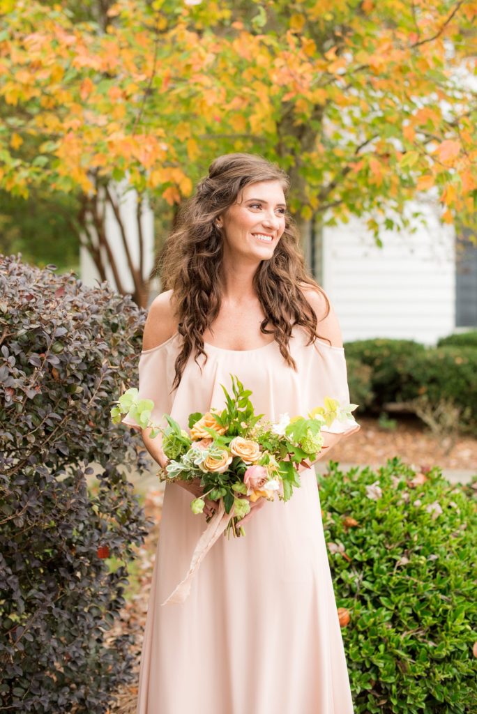 Small wedding in North Carolina with photos by Mikkel Paige Photography. A bridesmaid held a fall flower bouquet and wore a pink chiffon off the shoulder gown.