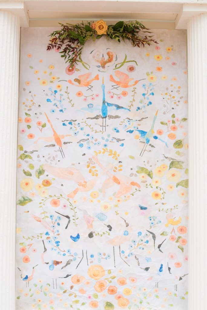 Small wedding in North Carolina with photos by Mikkel Paige Photography. The bride and groom got married in front of historic Leslie-Alford Mims House in Cary with a colorful fabric backdrop from Anthropology.