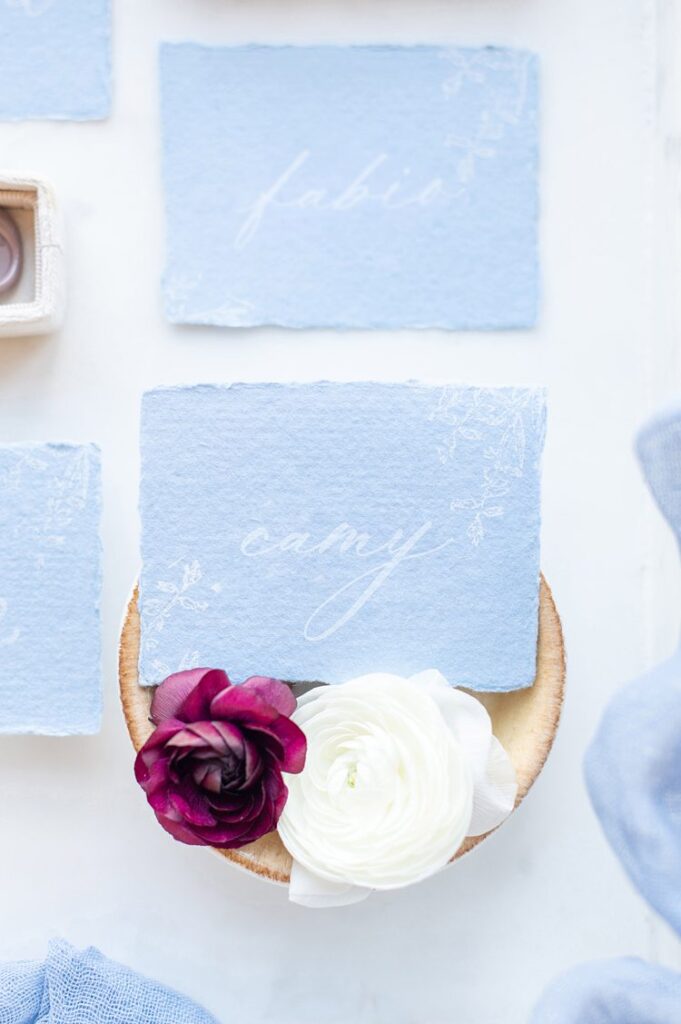 Blue paper with white calligraphy on place cards.