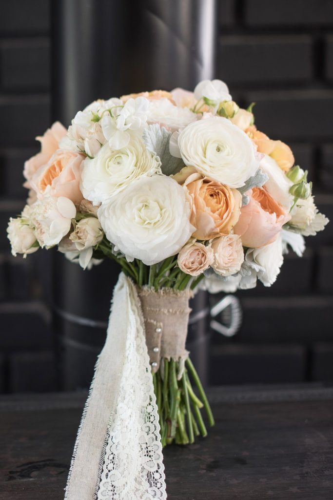 An intimate destination wedding elopement for a vineyard wedding in California at HammerSky Vineyards with Mikkel Paige Photography and a white and peach rose and ranunculus bouquet.
