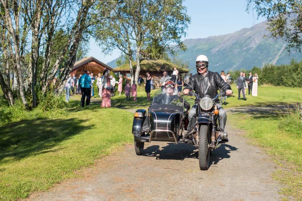 Norway Destination wedding photos by Mikkel Paige Photography with an outdoor ceremony in the Arctic Circle and a motorcycle and sidecar getaway vehicle for the bride and groom.