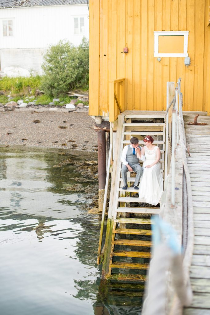 Norway Destination wedding photos by Mikkel Paige Photography in the Arctic Circle. The bride and groom had fun with pictures on the shore by a fjord.