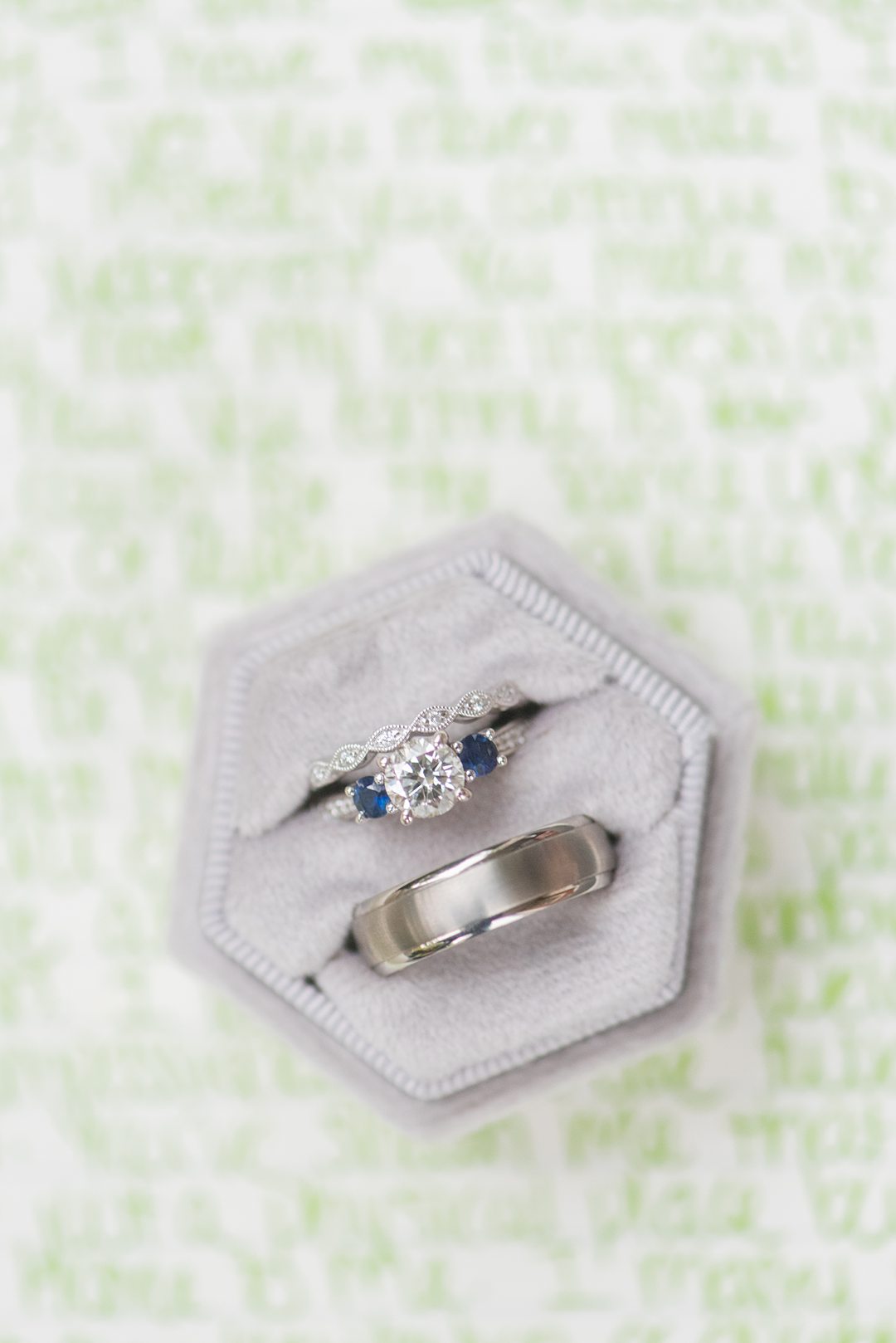 Rings in a grey velvet ring box captured by Mikkel Paige Photography. The detail photo was part of a small outdoor ceremony in Raleigh, NC.