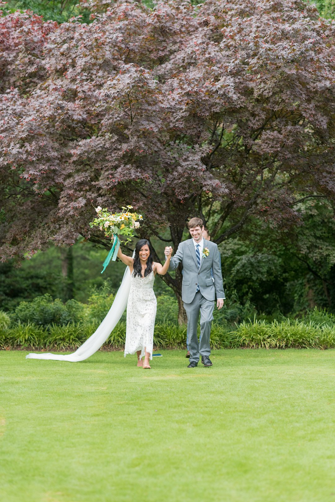 The bride and groom are pronounced husband and wife during their Raleigh, NC elopement in a park captured by Mikkel Paige Photography. #mikkelpaige #raleighweddings #smallwedding #ncelopement