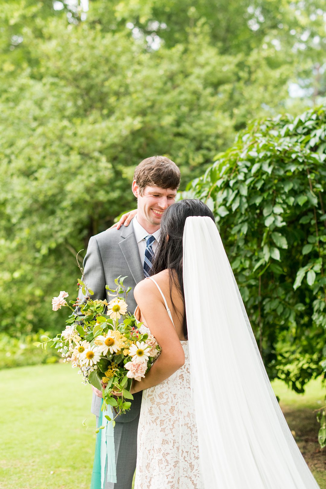 The bride and groom eloped and went to the alternative plan when Coronavirus foiled their original wedding. Wildflowers completed an outdoor ceremony in Raleigh, NC photographed by Mikkel Paige Photography. Hair and makeup by Wink, flowers by Mood Fleuriste. #mikkelpaige #raleighelopement #smalloutdoorceremony