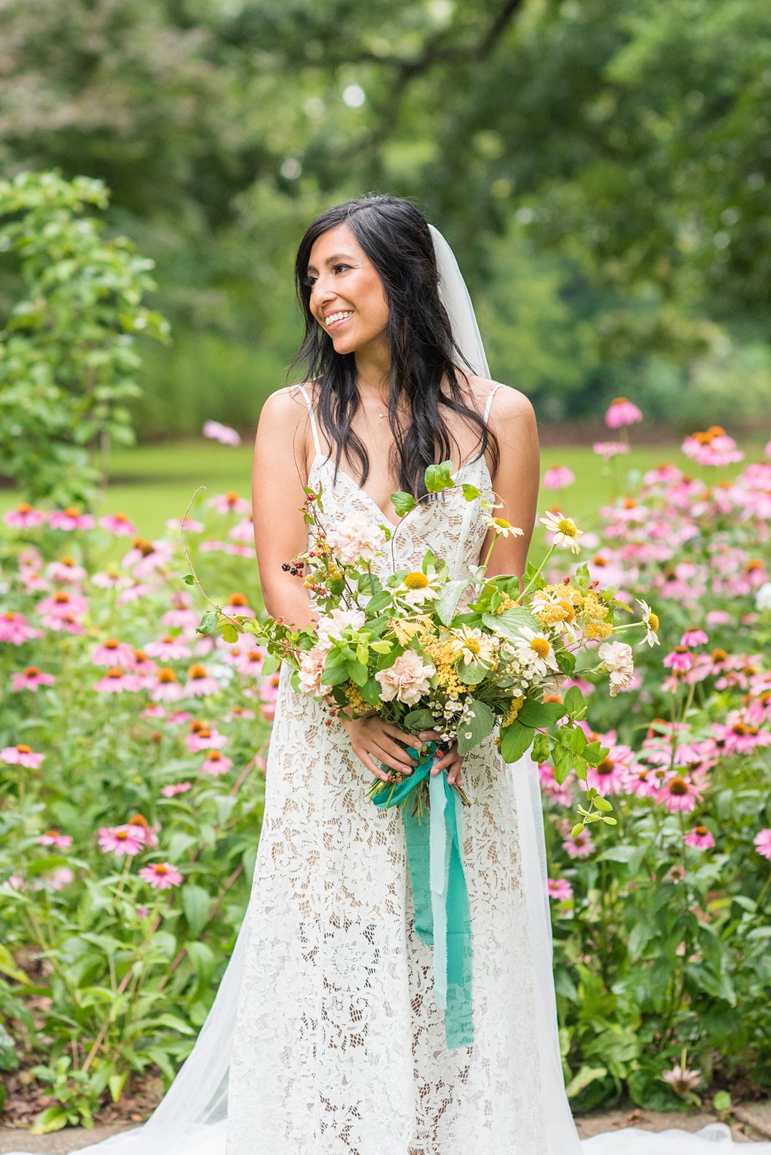 The bride after her small outdoor ceremony in a park in Raleigh, North Carolina. Photographed by Mikkel Paige Photography, hair and makeup by WINK and flowers by Mood Fleuriste. #mikkelpaige #bride #wildflowerbouquet #raleighnc