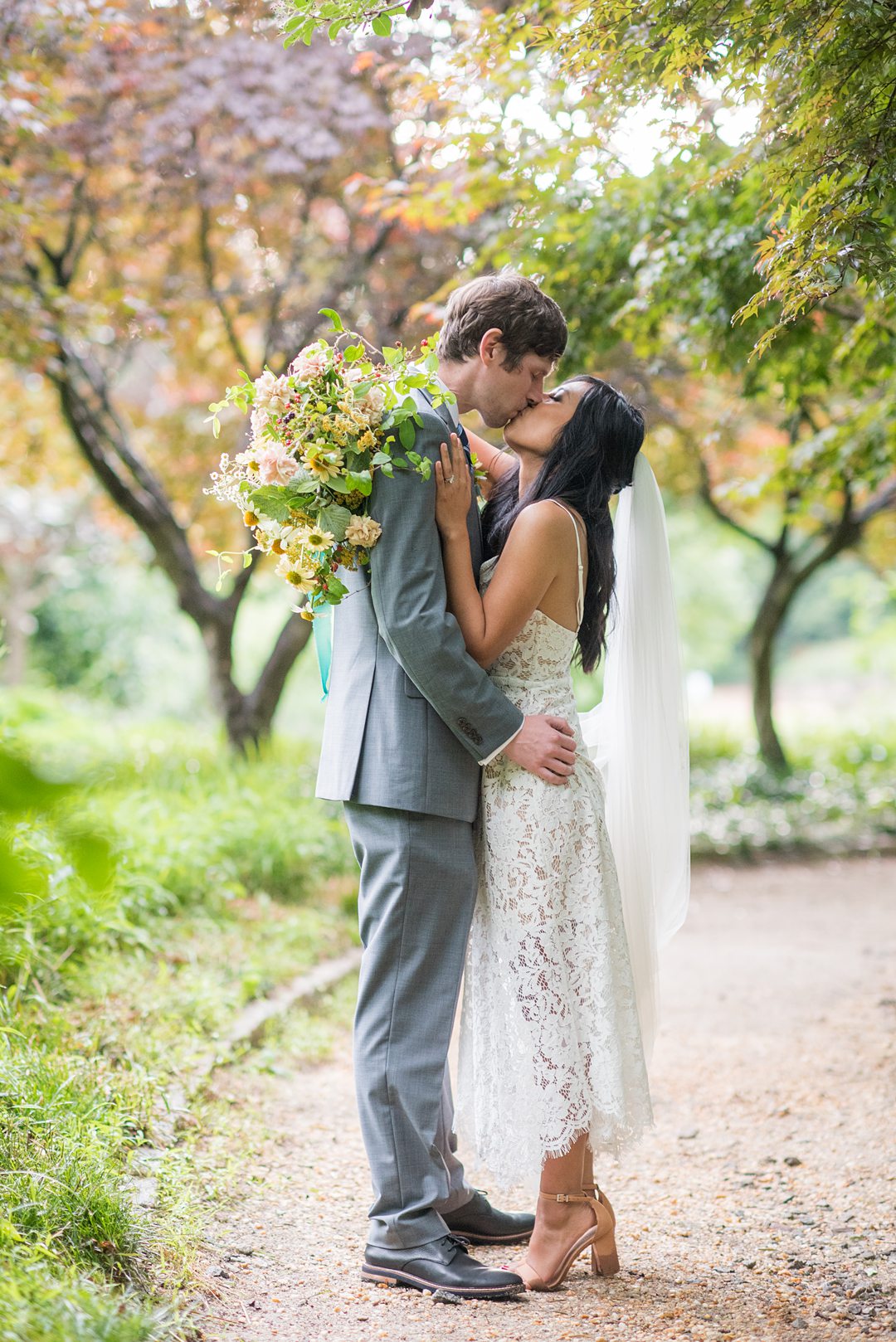 The bride and groom eloped and went to the alternative plan when Coronavirus foiled their original wedding. Wildflowers completed an outdoor ceremony in Raleigh, NC photographed by Mikkel Paige Photography. Hair and makeup by Wink, flowers by Mood Fleuriste. #mikkelpaige #raleighelopement #smalloutdoorceremony