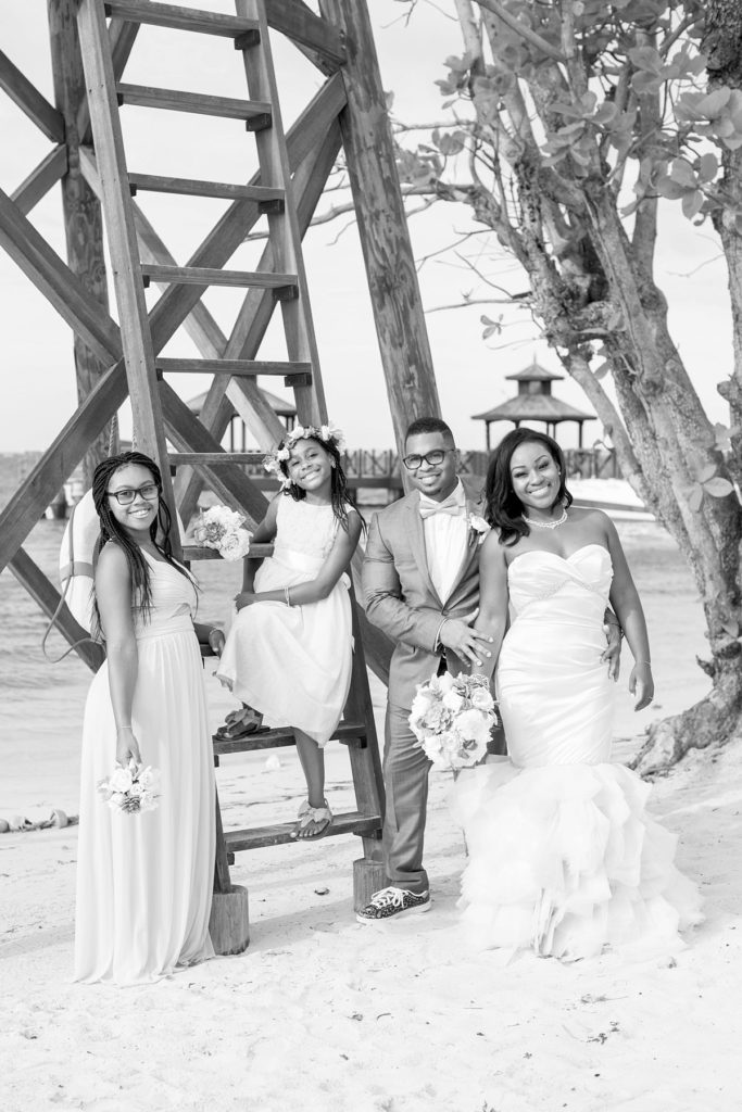 Bride, groom and their flower girls at their wedding on the beach at Iberostar in Jamaica. Photo by Mikkel Paige Photography.