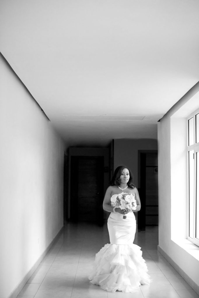 The bride walks down a hallway at Iberostar Resort on her wedding day.