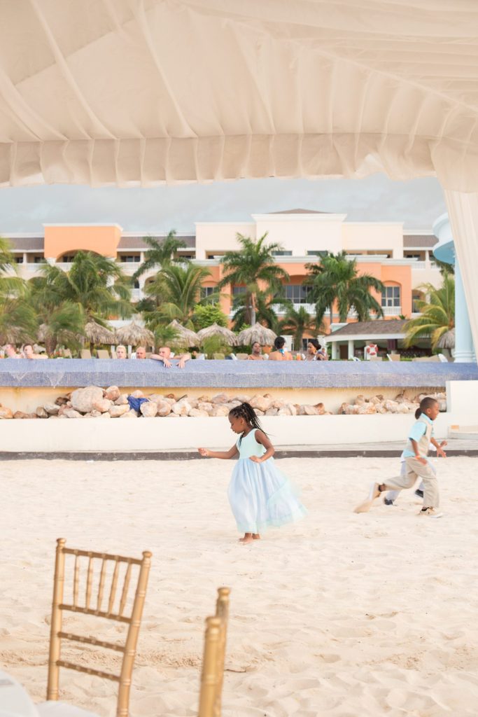 Kids playing in the sand at a wedding in Jamaica at Iberostar resort, by Mikkel Paige Photography.