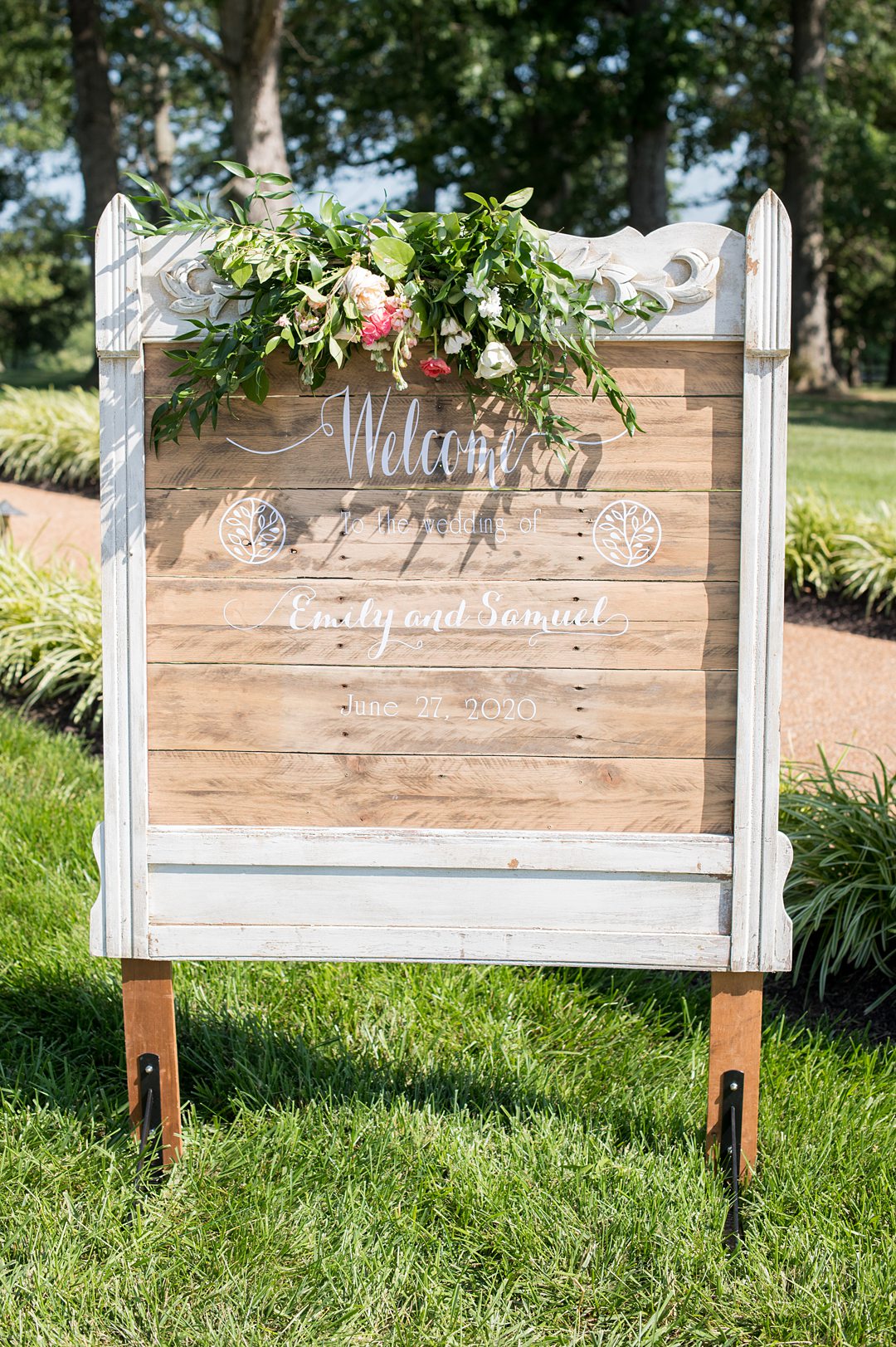 The wedding welcome sign with script letters on a custom wood frame for a small wedding at The Lodge at Mount Ida Farm overlooking the Blue Ridge Mountains. Photographed by Mikkel Paige Photography.