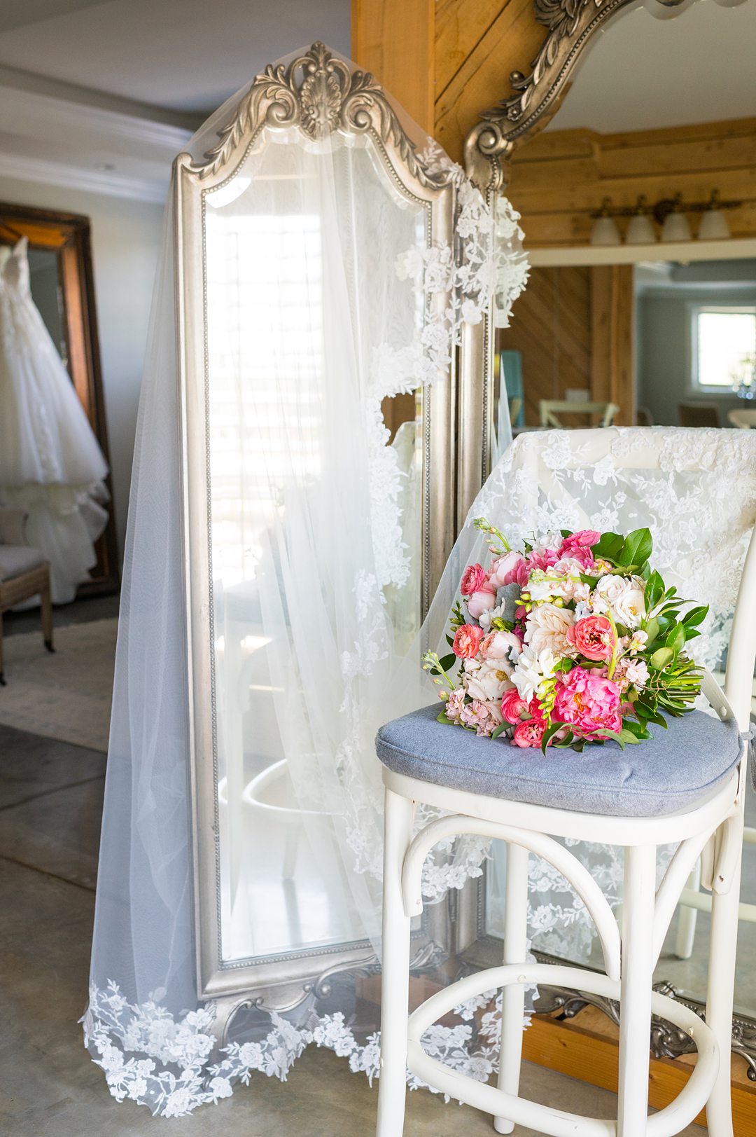 A bouquet, veil and wedding gown at the Bridal Suite at The Lodge at Mount Ida Farm. Photos by Mikkel Paige Photography and planning by Mary Elizabeth Events.