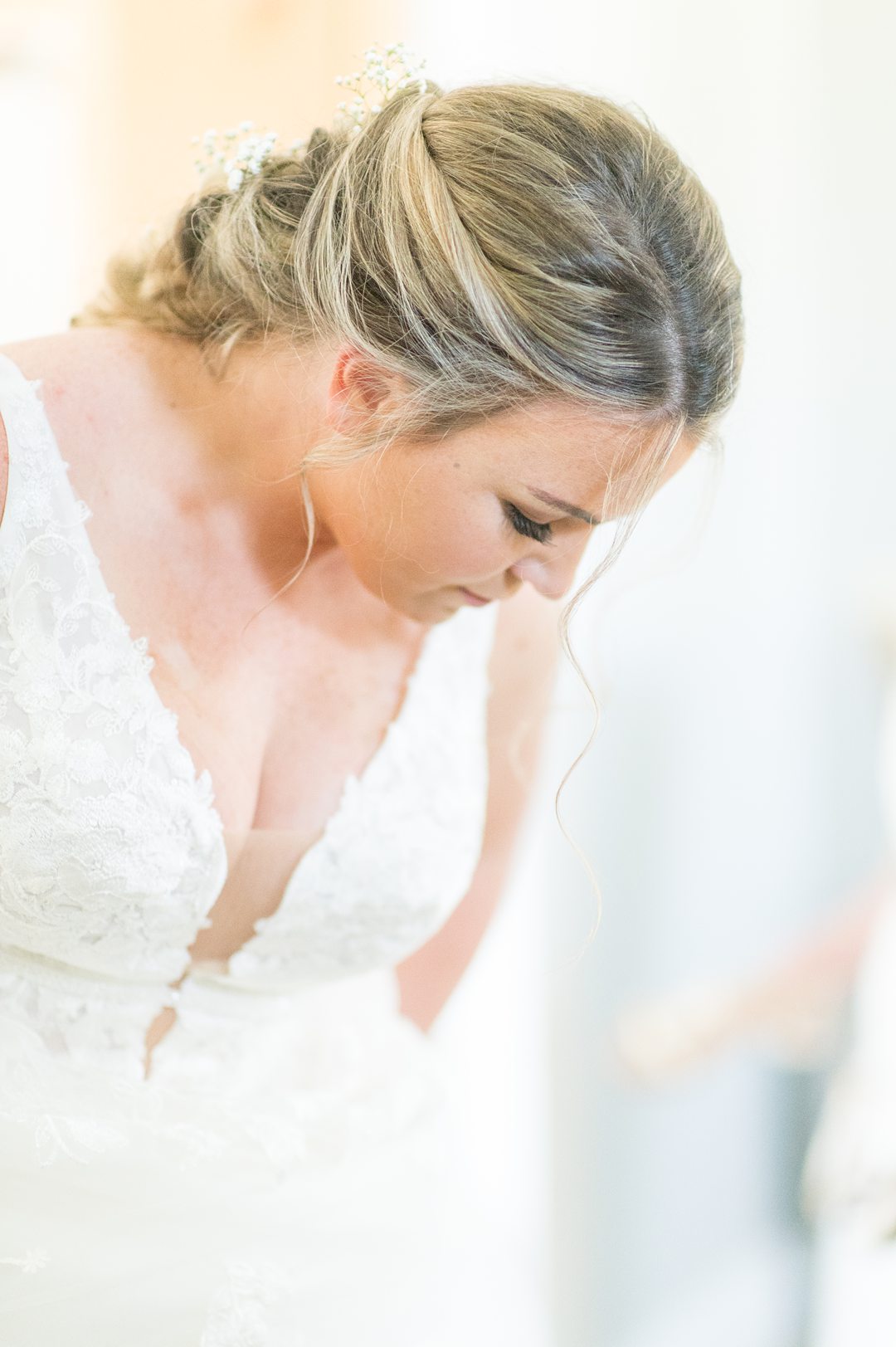 The bride prepared with her hair pulled back and white wedding gown at The Lodge at Mount Ida Farm. Pictures by Mikkel Paige Photography. #bridestyle #mikkelpaige