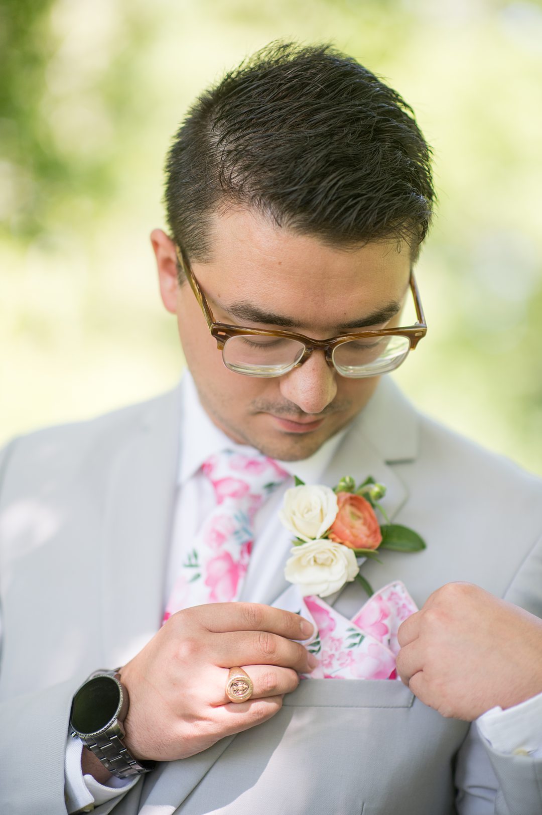 Groom in a grey suit with a pink floral tie and pocket square for a small wedding in Charlottesville, VA during COVID. Photos by Mikkel Paige Photography.