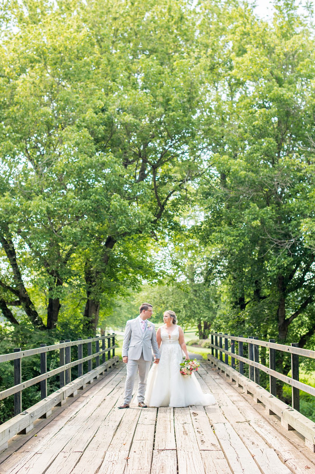 Bride and groom in the woods during their Charlottesville, VA wedding at The Lodge at Mount Ida Farm. Pictures by Mikkel Paige Photography.