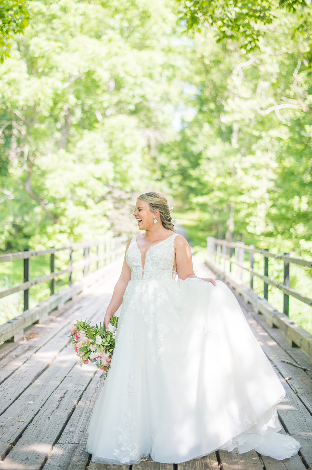 Bride in a tulle skirt and deep v gown with a summer bouquet with peonies by Mikkel Paige Photography. The wedding was at The Lodge at Mount Ida Farm in Charlottesville, VA.