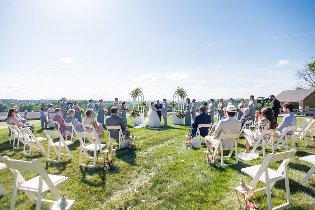 Socially distanced ceremony overlooking the Blue Ridge Mountains at the Lodge at Mount Ida Farm. Photos by Mikkel Paige Photography. #mikkelpaige #smallwedding #charlottesvillewedding