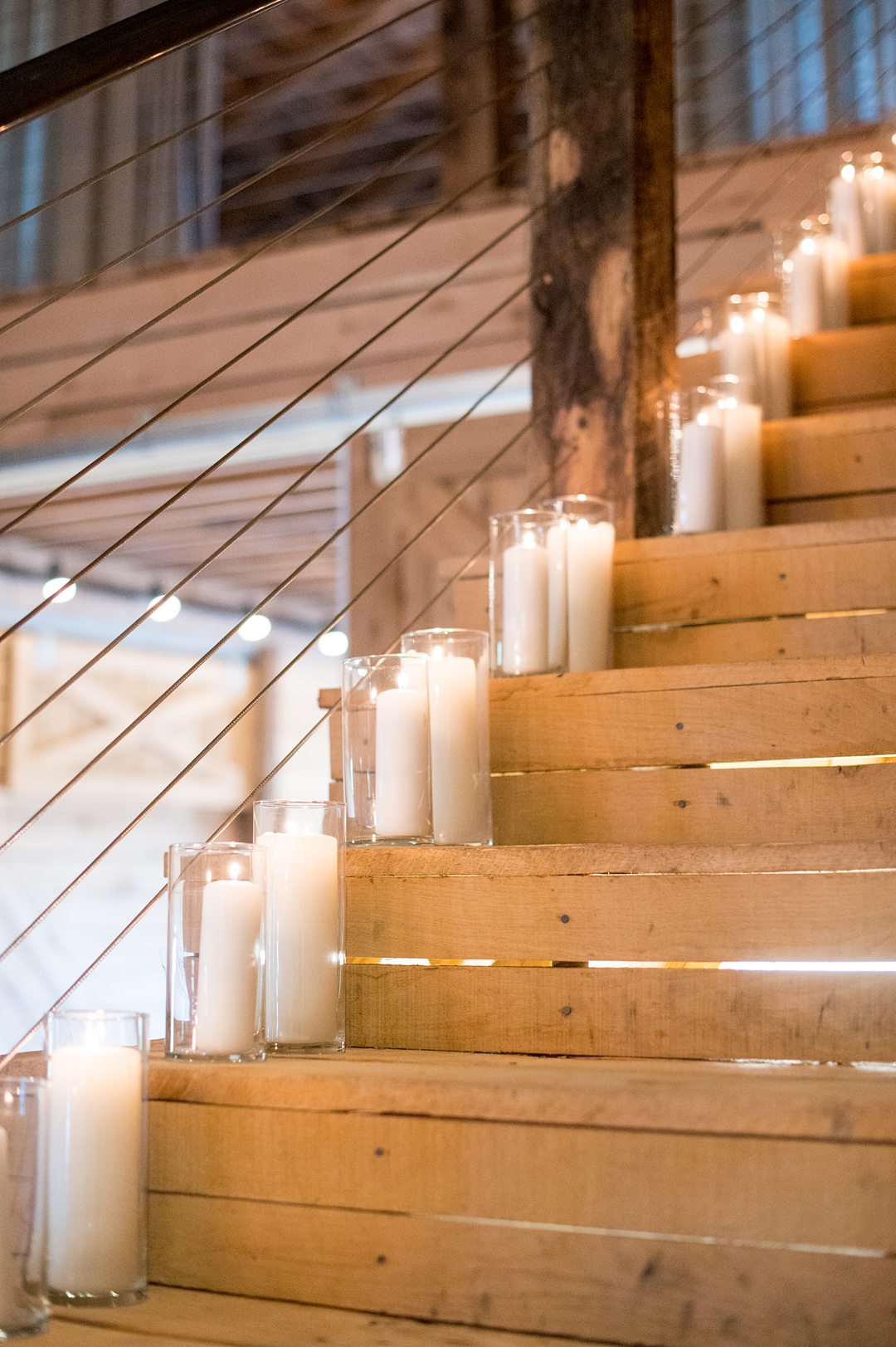 Candles lined the stairs at a small wedding reception at The Lodge at Mount Ida Farm in Charlottesville, VA. Photos by Mikkel Paige Photography. #mikkelpaige #charlottesvillewedding #CharlottesvilleVA #MountaIdaFarm #weddingreception