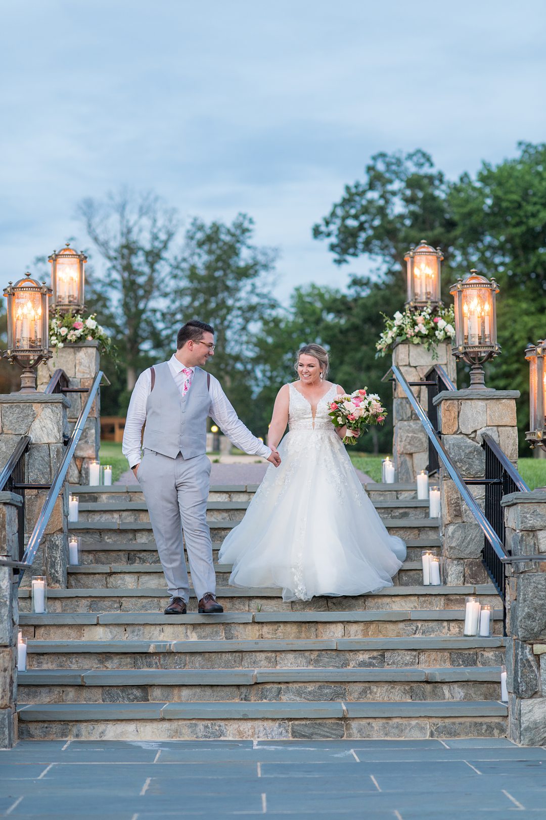 Dusk photo on the stairs of tThe Lodge at Mount Ida farm with the bride and groom surrounded by candlelight by Mikkel Paige Photography. Planning by Mary Elizabeth Events. #charlottesvillewedding #mikkelpaige #duskphotos #brideandgroom