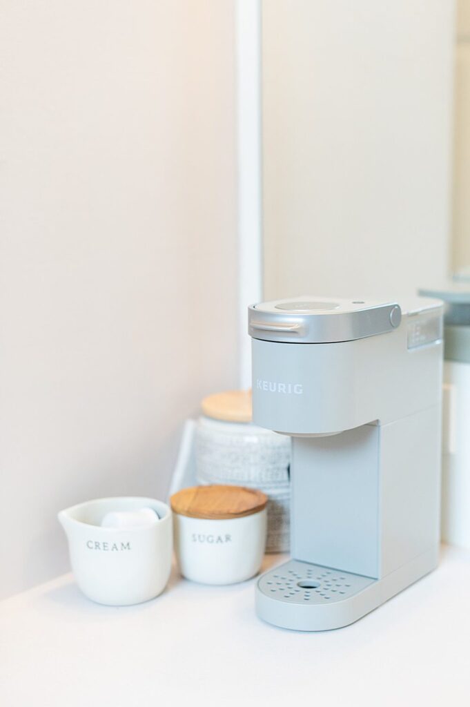 Grey Keurig coffee maker with sugar and cream next to it in the bridal suite at The Graham Mill in NC.