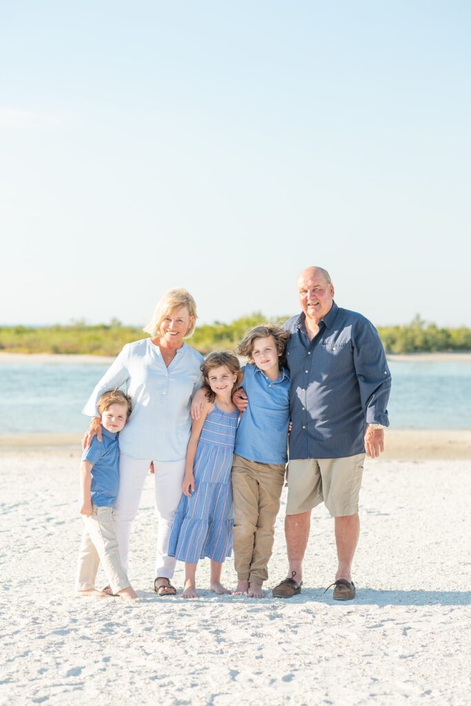 Family on a beach in Marco Island by Mikkel Paige Photography.