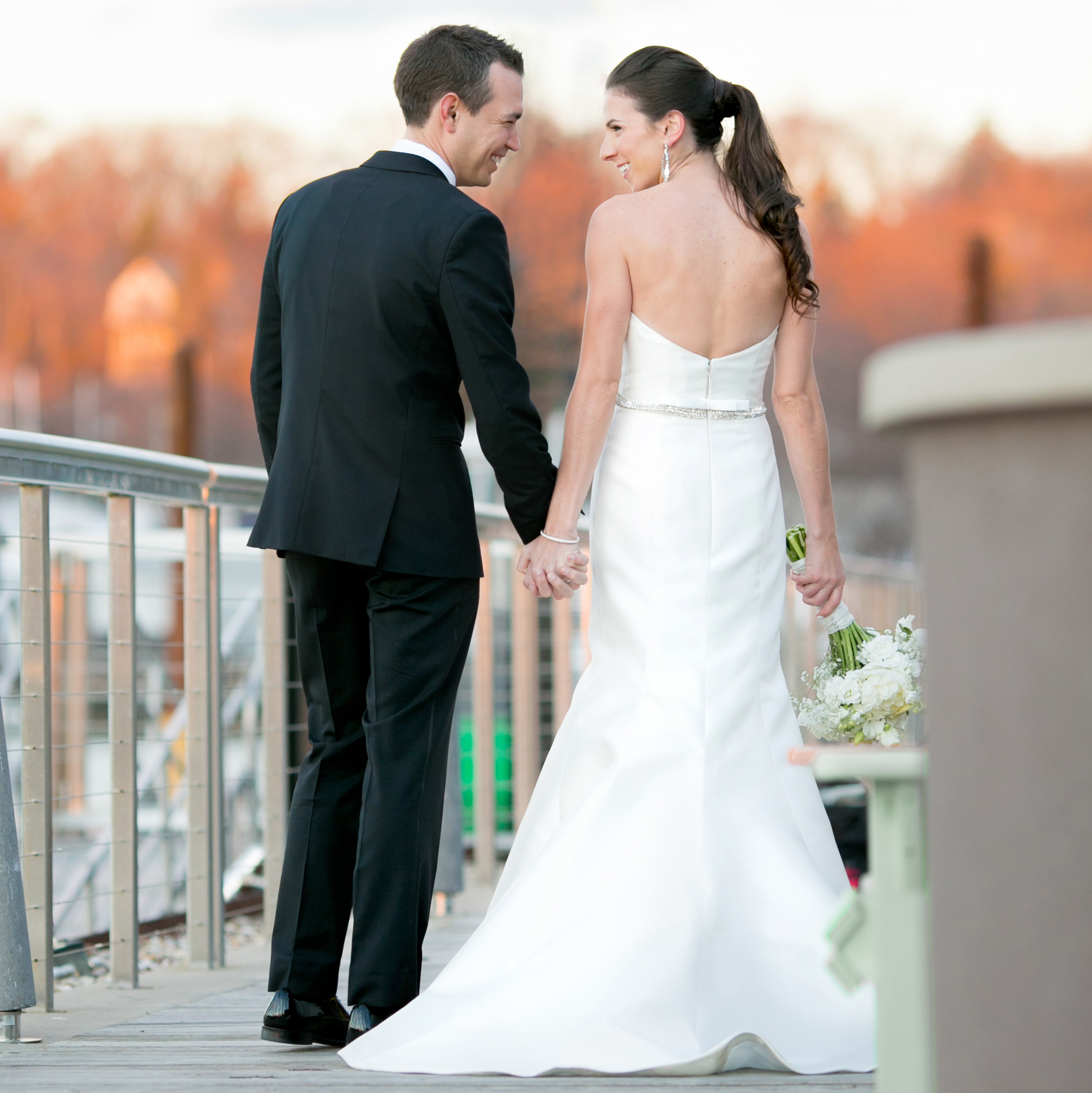 Groom and bride walking away from the camera at Huntington's Harbor Club at Prime.