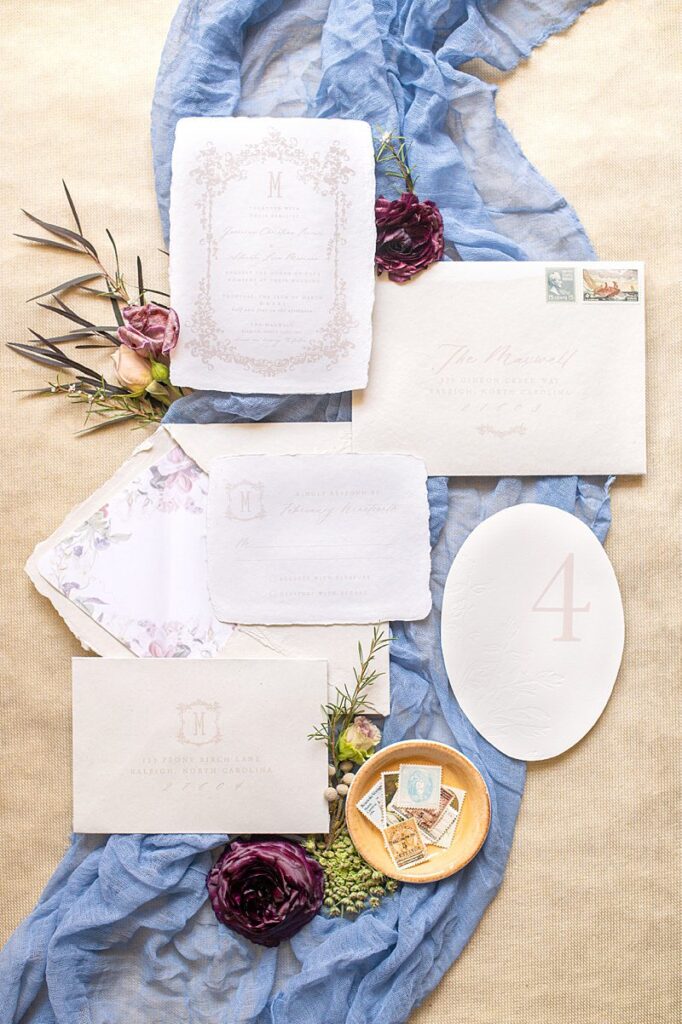 Italian inspired wedding invitation by Longest Time Design with tan, blue and floral elements.