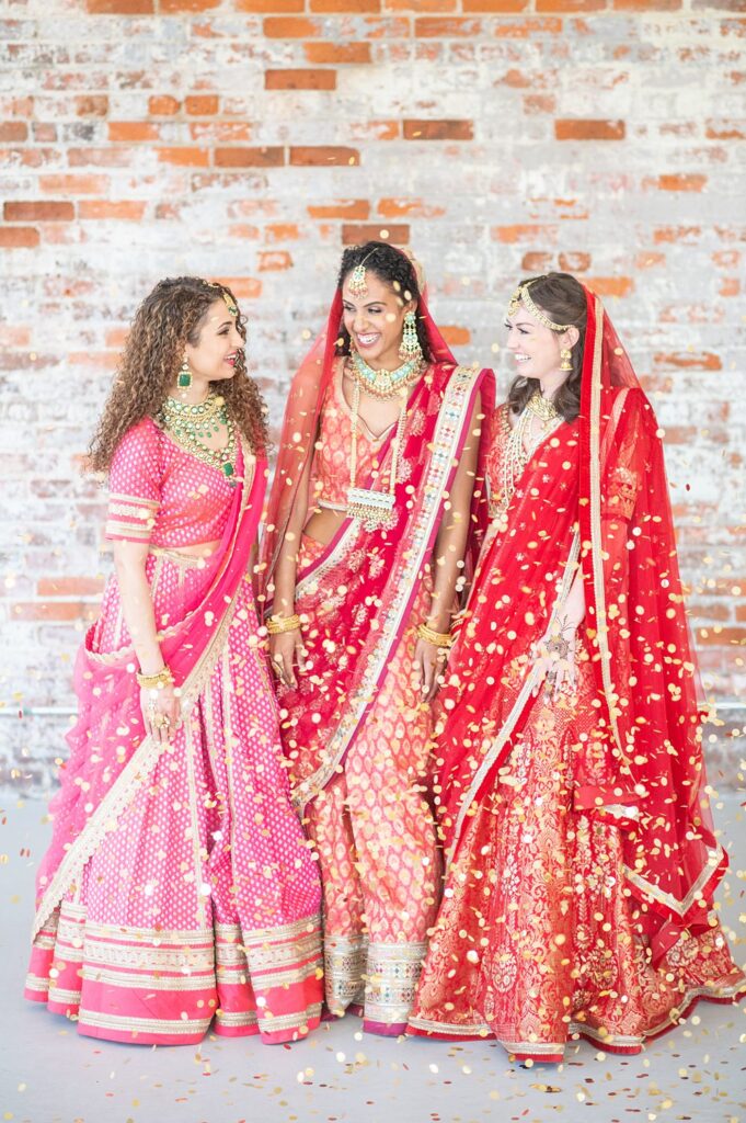 Indian wedding at The Graham Mill with bridesmaids dressed in red and pink sari dresses.