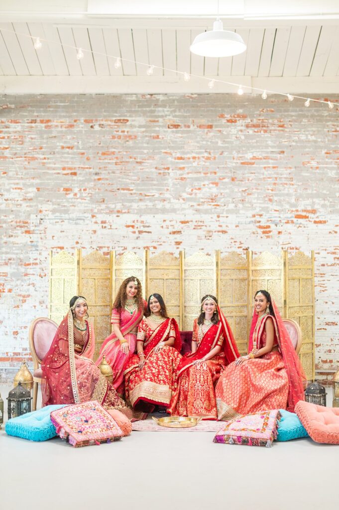 Indian wedding Mehndi party at The Graham Mill with bridesmaids dressed in red and pink sari dresses.
