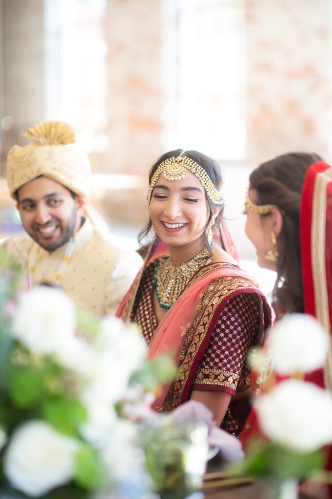 Indian bride at the colorful reception table at a wedding at The Graham Mill in NC.