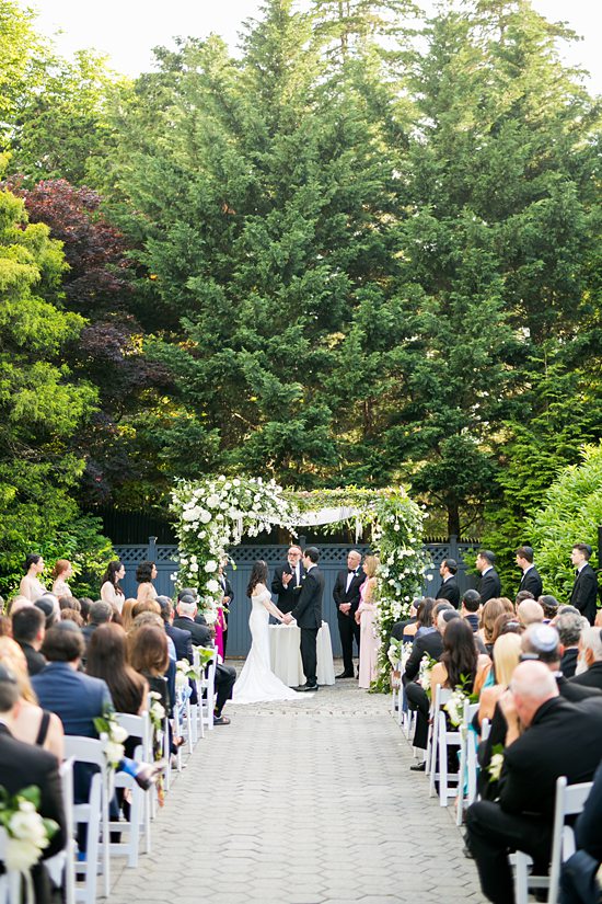 Outdoor ceremony at New York Botanical Gardens in NYC by Mikkel Paige Photography.