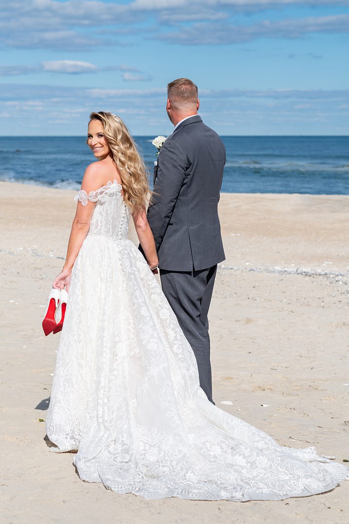 Bride and groom at the beach in NJ. Image by Mikkel Paige Photography.