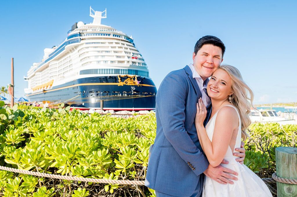 Bride and groom on Castaway Cay with Disney Wish cruise ship in the background for wedding photos by Mikkel Paige Photography.