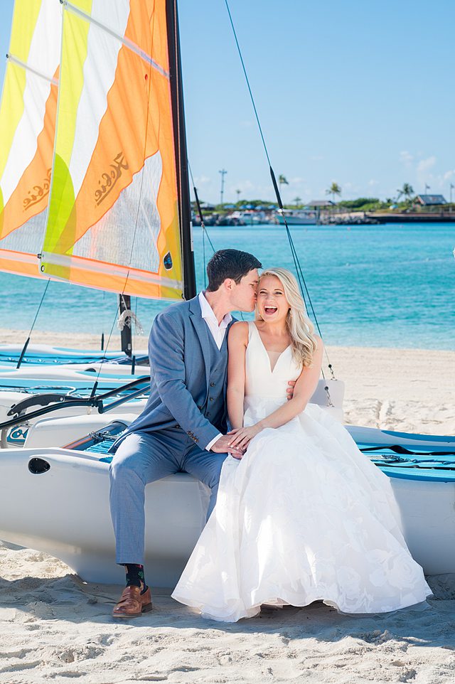 Bride and groom sitting on a colorful boat for Castaway Cay wedding photos by Mikkel Paige Photography.