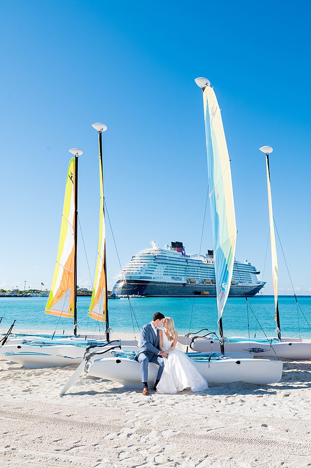 Bride and groom sitting on a colorful boat for Castaway Cay wedding photos by Mikkel Paige Photography.