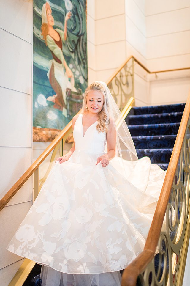 Disney Wish wedding photos by Mikkel Paige Photography of the bride walking down the stairs.