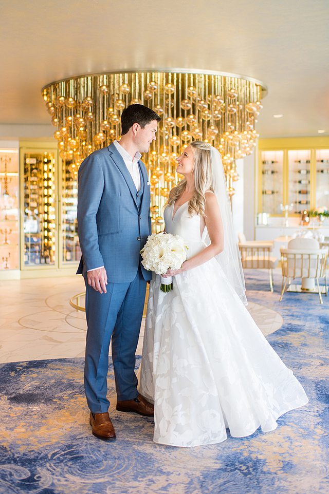 Bride and groom looking at each other in Enchante during their Disney Wish wedding photos by Mikkel Paige Photography on Disney Cruise Line.