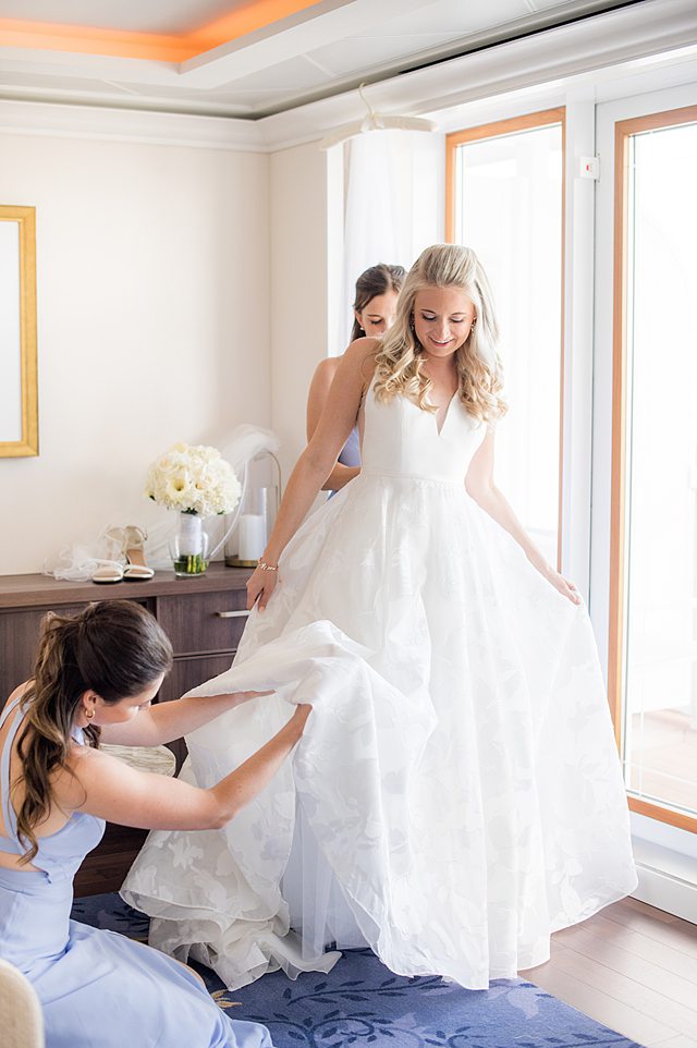 Bride getting ready for her wedding on Disney Wish with her bridesmaids on Disney Cruise Line. Photos by Mikkel Paige Photography.